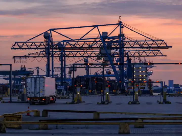Container cranes standing over the water at a Port of Rotterdam terminal