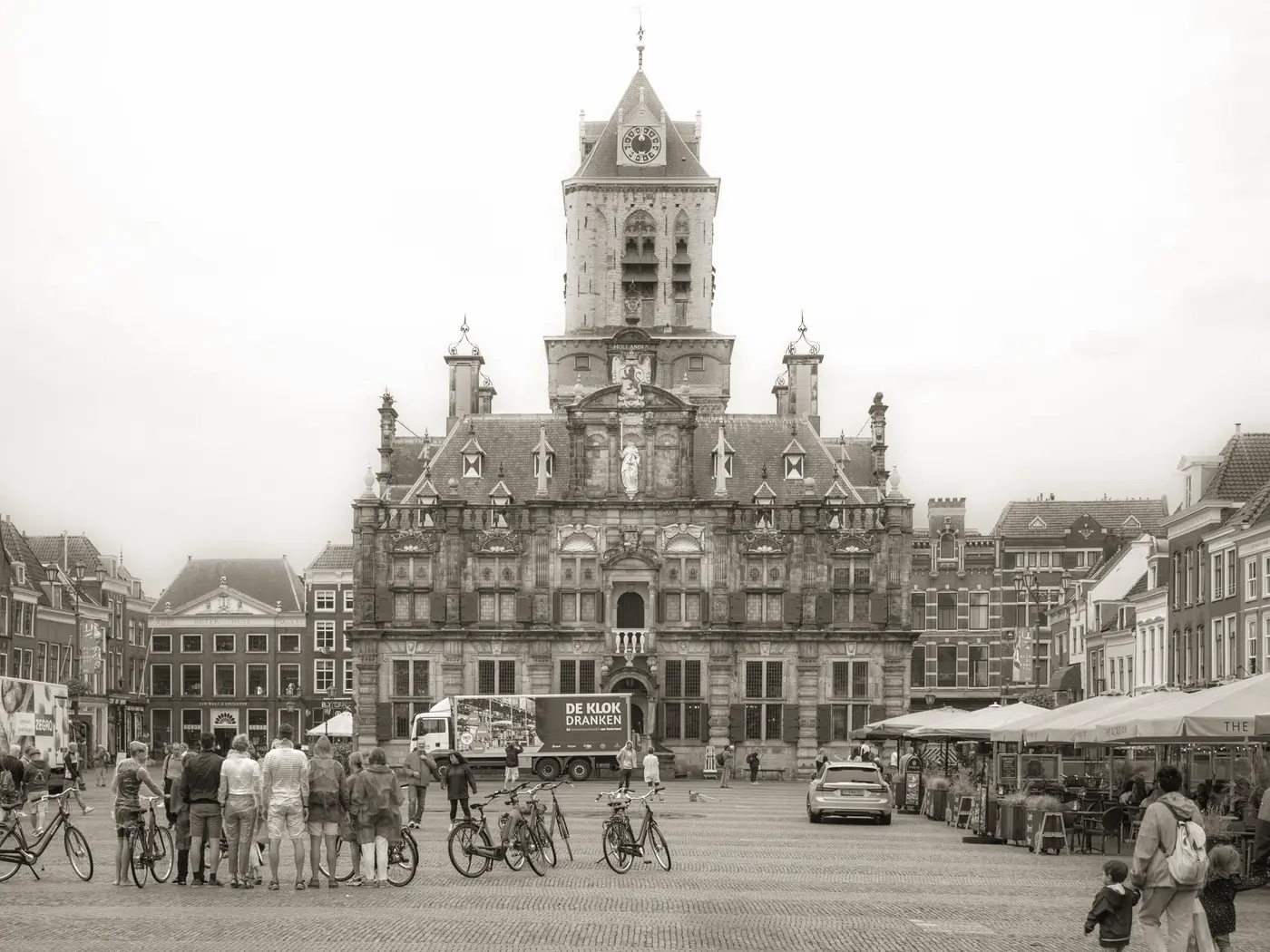 Delft's historic city hall and lively market square in daylight